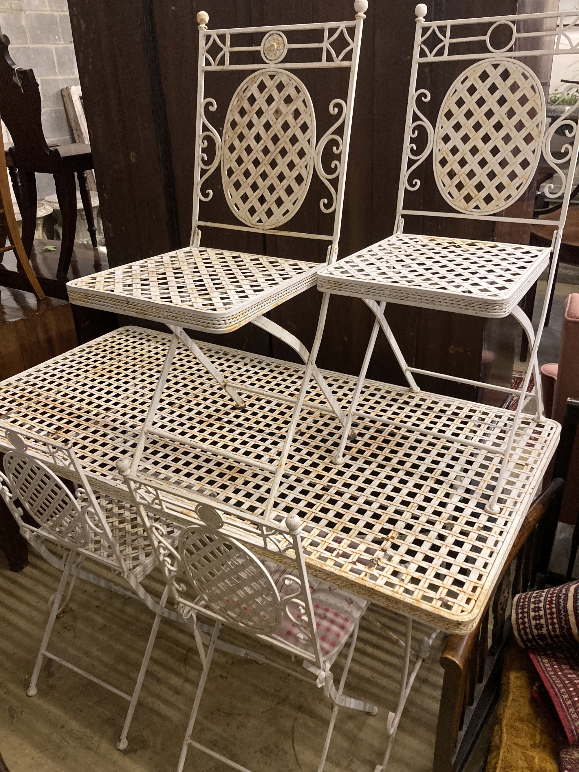 A rectangular metal garden table, width 150cm, depth 76cm, height 76cm together with four matching folding garden chairs